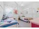 Bright bedroom features two beds with modern white canopies and colorful bedding, and neutral walls and carpet at 558 Pendleton Dr, Moncks Corner, SC 29461