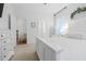 Bright bedroom with white furniture, a luxurious bed, and views into the en-suite bathroom at 558 Pendleton Dr, Moncks Corner, SC 29461