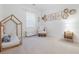 Bright bedroom features a modern spindle-style bed frame and a cozy reading nook with animal-themed wall art at 558 Pendleton Dr, Moncks Corner, SC 29461