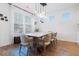 Elegant dining room with modern lighting, wooden table and six chairs at 558 Pendleton Dr, Moncks Corner, SC 29461