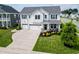 Beautiful two-story home featuring a three-car garage, landscaped yard, and inviting front porch at 558 Pendleton Dr, Moncks Corner, SC 29461