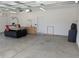 Spacious garage with epoxy flooring features a CNC machine, wall-mounted air conditioner, and storage cabinets at 558 Pendleton Dr, Moncks Corner, SC 29461