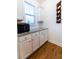 Bright kitchen area with granite countertops, white cabinets, a microwave, and convenient wine rack at 558 Pendleton Dr, Moncks Corner, SC 29461
