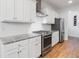 Modern kitchen features white cabinets, stainless steel appliances, granite countertops, and a stylish backsplash at 558 Pendleton Dr, Moncks Corner, SC 29461