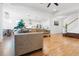 Bright, open-concept living room features hardwood floors, modern lighting and comfortable seating at 558 Pendleton Dr, Moncks Corner, SC 29461