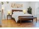 Beautiful main bedroom with hardwood floors, art, lamps, bench, and a large window with natural light at 558 Pendleton Dr, Moncks Corner, SC 29461