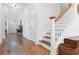 Open staircase featuring hardwood floors and a stylish banister leading to the upper level at 558 Pendleton Dr, Moncks Corner, SC 29461