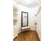 Beautiful walk-in closet with white shelving, drawers, and a stylish accent mirror at 558 Pendleton Dr, Moncks Corner, SC 29461