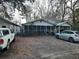Front exterior of a home with large trees and a gravel driveway and a screened porch at 6385 Sc-162, Hollywood, SC 29449