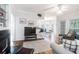 Open-concept living room with hardwood floors, fireplace, breakfast bar, and natural light at 700 Daniel Ellis Dr # 4107, Charleston, SC 29412