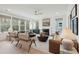 Bright living room with multiple seating areas, neutral colors, large windows and modern ceiling fan at 705 Maynard Ln, Summerville, SC 29486