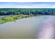 Scenic aerial view showing the river and homesites nestled among mature trees at 7074 W Constellation Dr, North Charleston, SC 29418