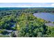 Wide aerial of the home nestled among mature trees with waterfront views at 7074 W Constellation Dr, North Charleston, SC 29418