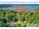 Beautiful aerial view of the home nestled among trees with a river view in the background at 7074 W Constellation Dr, North Charleston, SC 29418