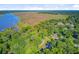 Aerial view of a home surrounded by mature trees and close proximity to the river and marsh at 7074 W Constellation Dr, North Charleston, SC 29418