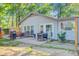 A patio area with room to grill and play foosball, surrounded by a lush, tree-lined yard at 7074 W Constellation Dr, North Charleston, SC 29418