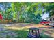 Expansive backyard with mature trees, partially fenced, and ready for outdoor activities and enjoyment at 7074 W Constellation Dr, North Charleston, SC 29418