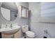 A bathroom with a large sink, a toilet, a mirror and a cabinet above the toilet at 7074 W Constellation Dr, North Charleston, SC 29418