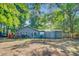 Exterior view of the backyard, featuring mature trees and ample space for outdoor enjoyment at 7074 W Constellation Dr, North Charleston, SC 29418
