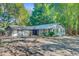 Front exterior showcasing the building with ample parking and mature landscaping at 7074 W Constellation Dr, North Charleston, SC 29418