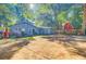 Back of home with large, lush backyard and a red barn visible in the background at 7074 W Constellation Dr, North Charleston, SC 29418