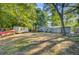 A sprawling backyard with ample space, mature trees, and a trailer parked nearby at 7074 W Constellation Dr, North Charleston, SC 29418
