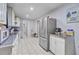 Bright kitchen with stainless steel refrigerator and tile flooring at 7074 W Constellation Dr, North Charleston, SC 29418