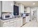 Functional kitchen with white cabinetry, stainless steel appliances, and tile floors at 7074 W Constellation Dr, North Charleston, SC 29418