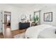 Tranquil bedroom featuring hardwood floors, a dark dresser, with a view into the living space beyond at 725 Maynard Ln, Summerville, SC 29486