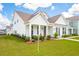Beautifully landscaped two-story home featuring a well-manicured lawn and inviting front porch at 725 Maynard Ln, Summerville, SC 29486