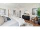Bright main bedroom featuring white walls, hardwood floors, ceiling fan, and stylish decor at 725 Maynard Ln, Summerville, SC 29486