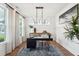 Bright office with a dark desk, stylish chandelier, large windows, and elegant decor at 725 Maynard Ln, Summerville, SC 29486