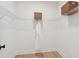 Walk-in closet with built-in shelving and a hanging rod with a white bathrobe at 729 Maynard Ln, Summerville, SC 29486
