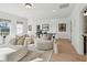 Bright living room with lots of natural light, three large windows, and wood floors at 729 Maynard Ln, Summerville, SC 29486