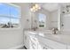 Bright bathroom with double sink vanity, quartz countertops, bronze fixtures, and a large window at 764 Maynard Ln, Summerville, SC 29486