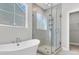 Bathroom featuring a glass shower, a standalone tub, and a large window providing natural light at 764 Maynard Ln, Summerville, SC 29486