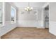 Bright dining room featuring wood floors, large windows, decorative molding, and a stylish light fixture at 764 Maynard Ln, Summerville, SC 29486