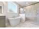 Luxurious bathroom with a large tub, walk-in shower, and modern vanity with granite countertops at 770 Maynard Ln, Summerville, SC 29486
