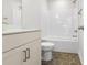 Well-lit bathroom with shower and bathtub, hexagon flooring and modern vanity at 770 Maynard Ln, Summerville, SC 29486
