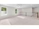 Bright bonus room with carpet flooring, ceiling fan, and natural light from two windows and stair access at 770 Maynard Ln, Summerville, SC 29486
