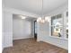 Bright dining room with elegant wainscoting, hardwood floors, and stylish light fixture at 770 Maynard Ln, Summerville, SC 29486