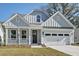 Charming light blue two-story home with an attached garage and welcoming front porch at 770 Maynard Ln, Summerville, SC 29486