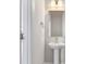 Stylish powder room with pedestal sink, modern mirror, and gold hardware at 770 Maynard Ln, Summerville, SC 29486