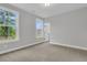 Cozy bedroom with natural light, carpeted floors, and views of lush greenery through the windows at 773 Maynard Ln, Summerville, SC 29486