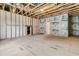 Unfinished room displaying exposed wood framing, with a door and window; ready for customization at 773 Maynard Ln, Summerville, SC 29486