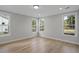 Sunlit bedroom featuring hardwood floors and multiple windows offering pleasant views at 778 Maynard Ln, Summerville, SC 29486