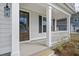 Inviting front porch with white columns, dark door, and stylish outdoor lighting at 778 Maynard Ln, Summerville, SC 29486