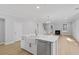 Bright kitchen with a large island and stainless steel appliances, flowing into an open-plan living area at 778 Maynard Ln, Summerville, SC 29486