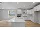 Open-concept kitchen featuring white cabinets, stainless steel appliances, and hardwood flooring at 778 Maynard Ln, Summerville, SC 29486