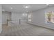 Large, bright loft space showcasing soft carpeting, white walls, abundant lighting, and a charming railing at 778 Maynard Ln, Summerville, SC 29486